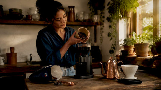Woman grinding specialty coffee beans at home