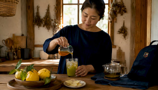 Woman pouring yuzu syrup into iced tea glass
