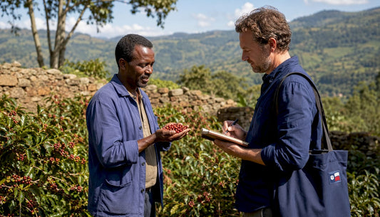 Coffee farmer and roaster inspecting coffee cherries