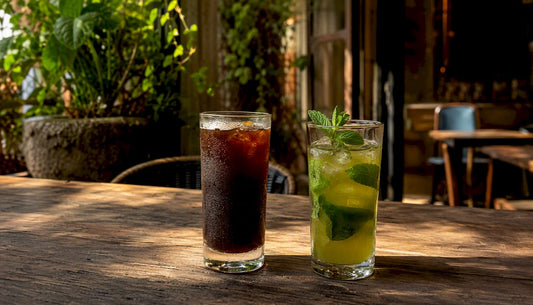 Close-up of iced coffee and iced green tea glasses