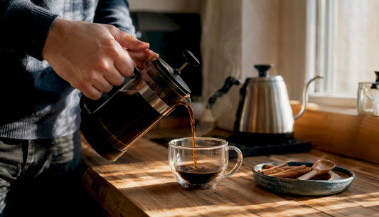 Hands pressing French press plunger