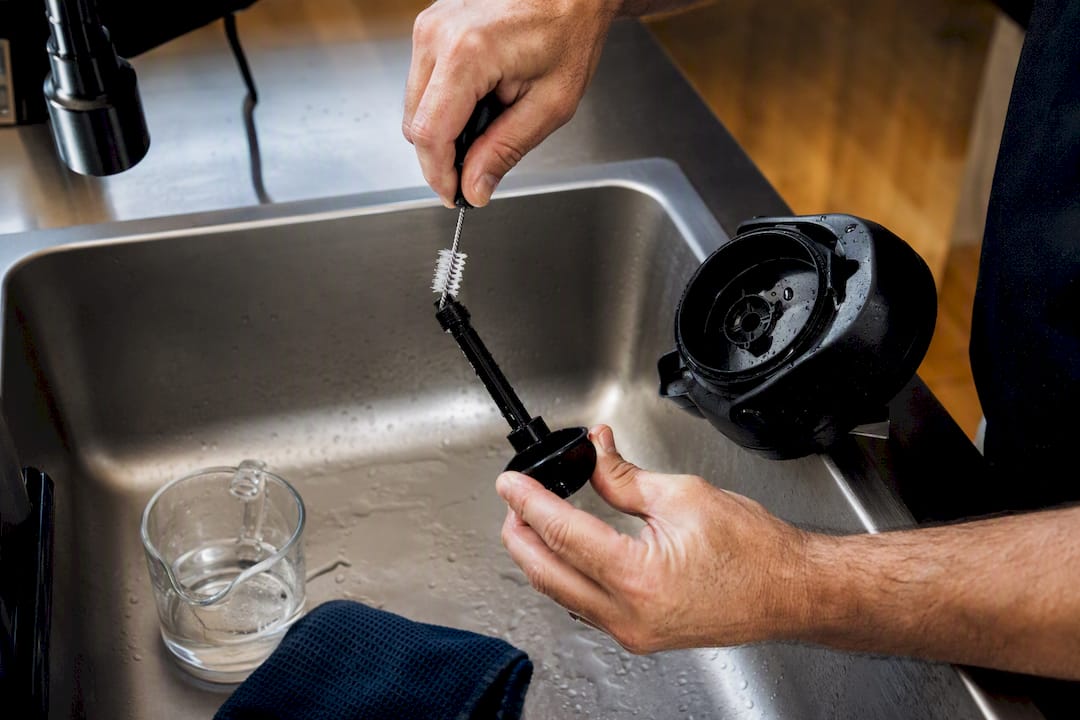 Hand cleaning a coffee airpot pump stem
