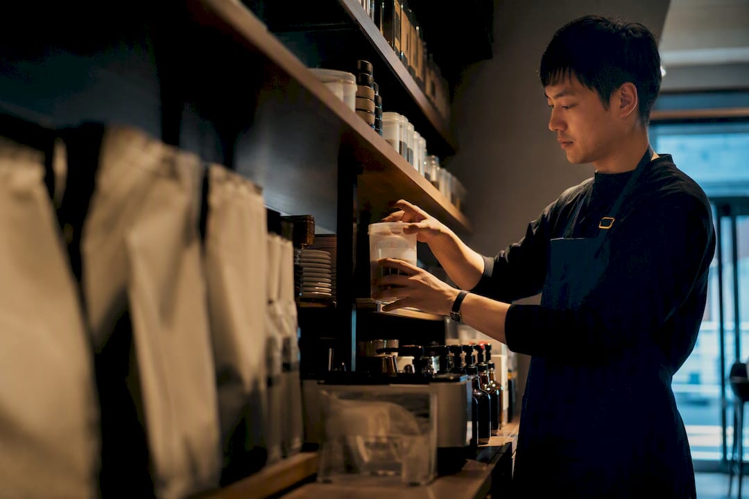 Café operator organizing categorized supplies
